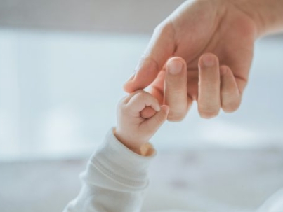 Close-up little hand of child baby holding hand of mother, A newborn holds on to mom's, dad's finger, Love and relationship with infant, Care and support, Dreaming and protection